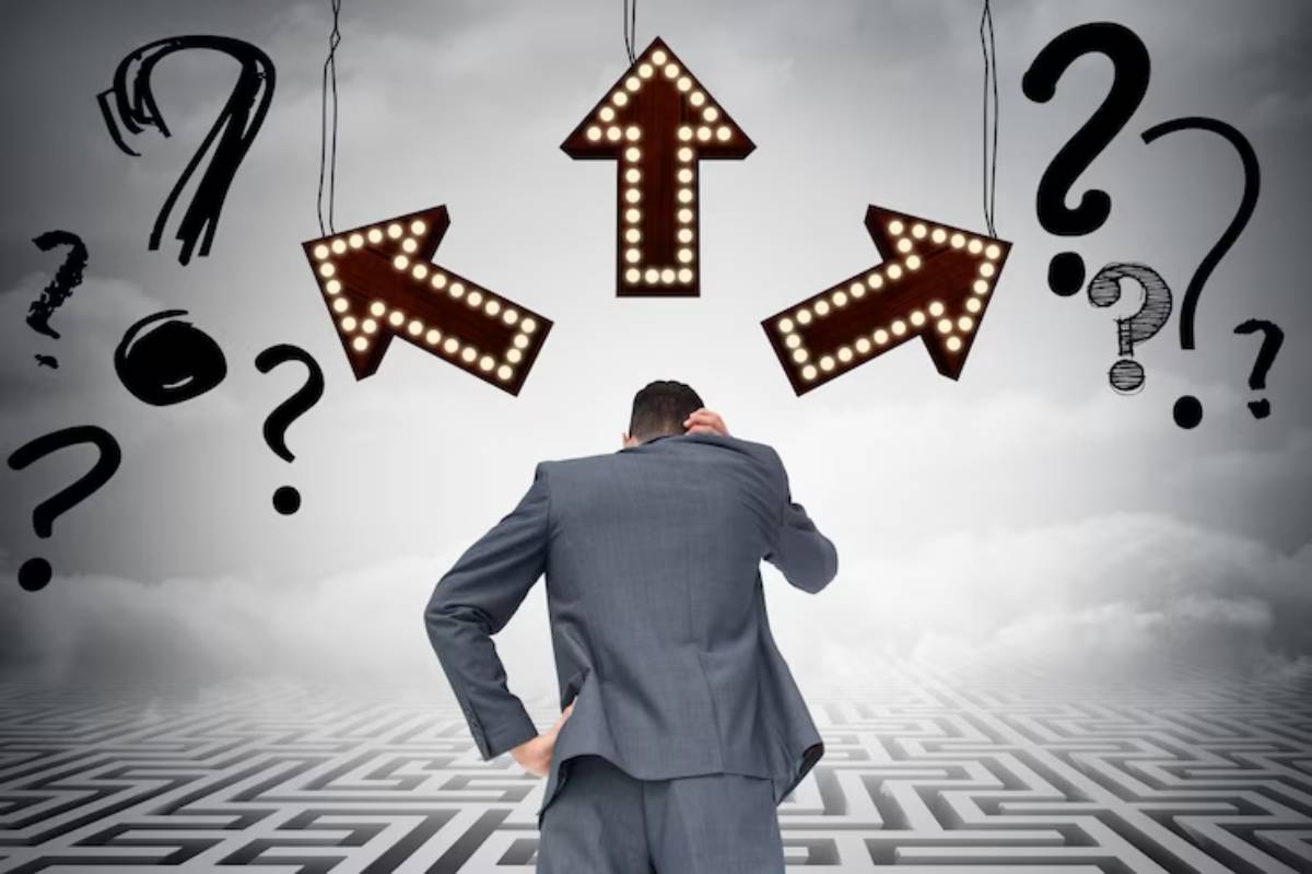 A man in a suit stands confused, facing three lit directional arrows surrounded by question marks, symbolizing decision-making.